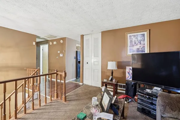 a bedroom with furniture and a flat screen tv