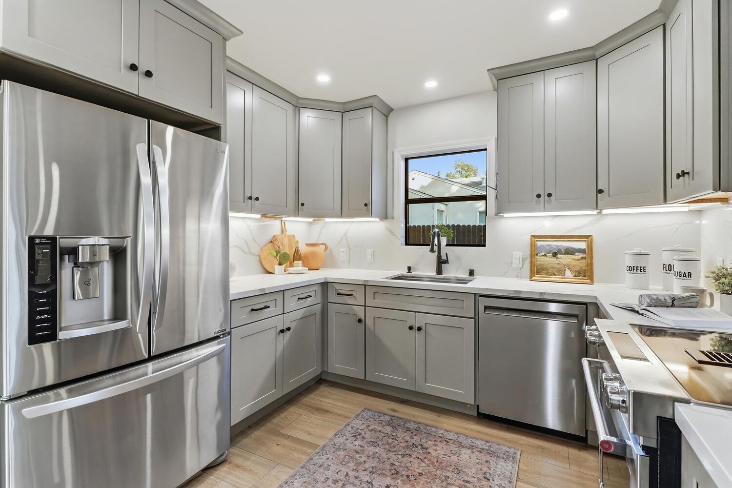 2860 Tioga Way Sacramento, CA 95821 - Photo 18 of 53 a kitchen with stainless steel appliances granite countertop a refrigerator sink and cabinets