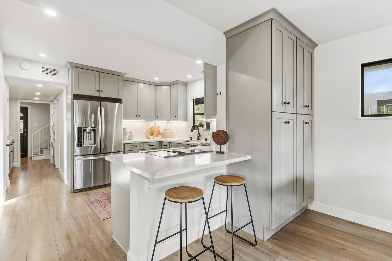2860 Tioga Way Sacramento, CA 95821 - Photo 19 of 53 a kitchen with kitchen island a refrigerator stove and wooden floor