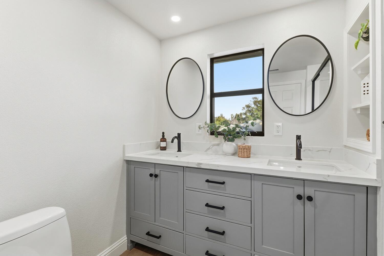 2860 Tioga Way Sacramento, CA 95821 - Photo 27 of 53 a bathroom with a double vanity sink and a mirror