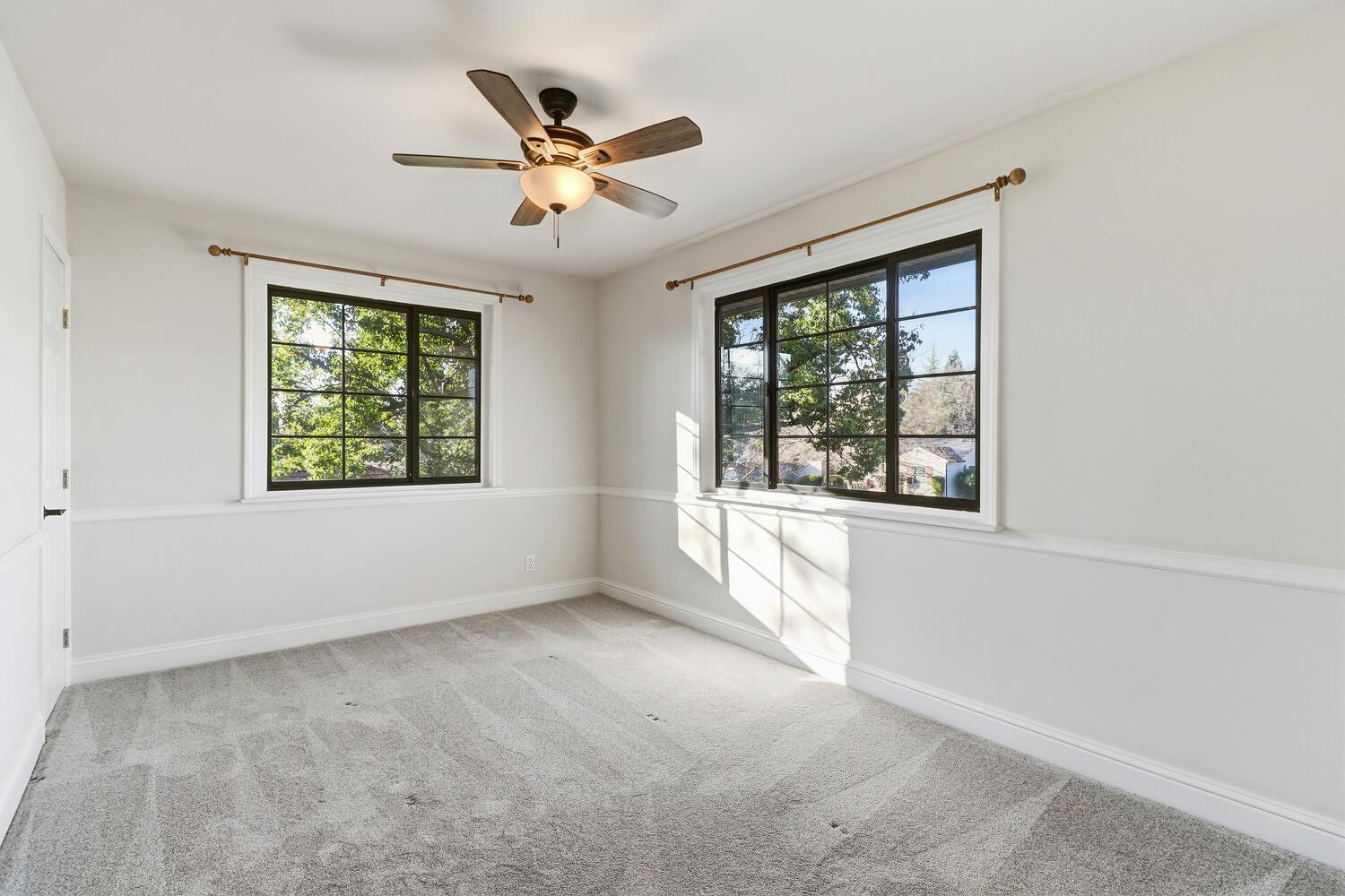 2860 Tioga Way Sacramento, CA 95821 - Photo 30 of 53 an empty room with windows and chandelier fan
