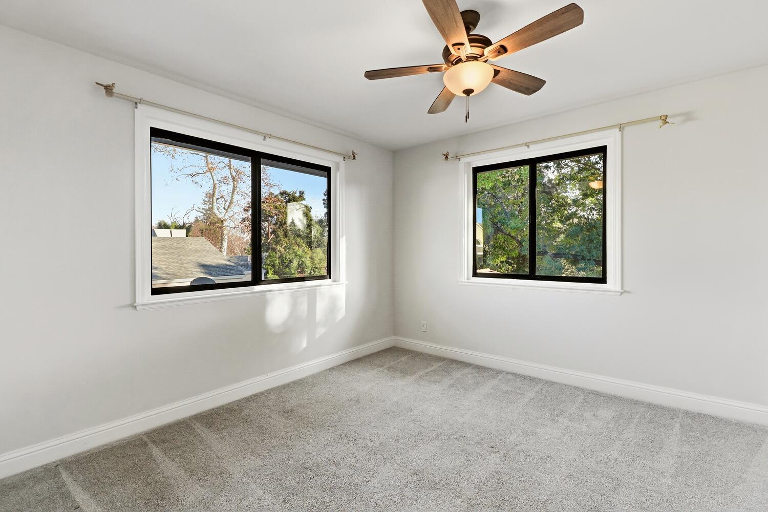 2860 Tioga Way Sacramento, CA 95821 - Photo 32 of 53 an empty room with windows and fan