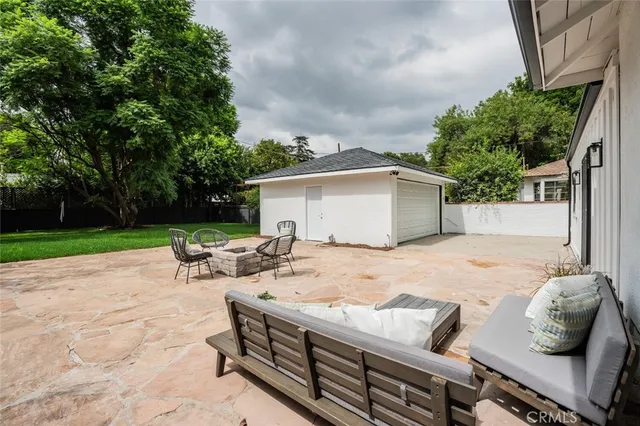 a view of a patio with couple of chairs