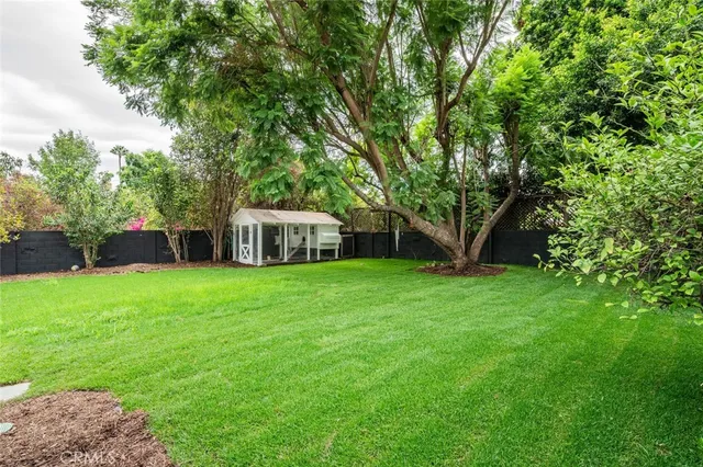 a view of a small house with a yard