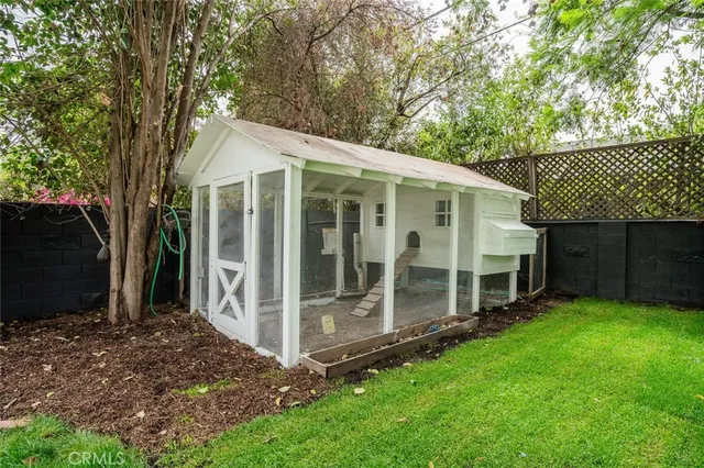 a front view of a house with yard and green space