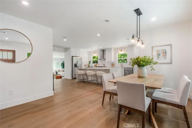 a dining room with furniture and wooden floor