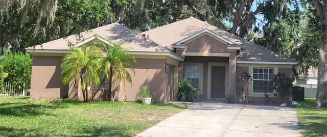 a view of a house with a yard and plants