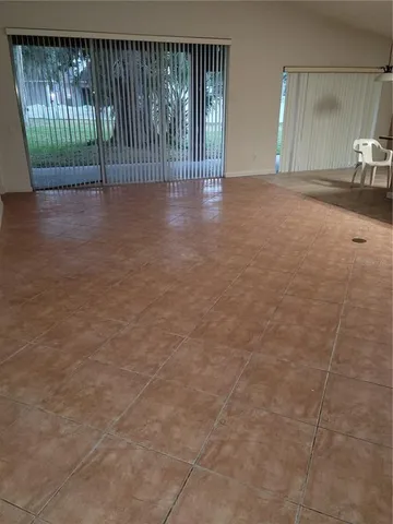 a view of a house with backyard and patio