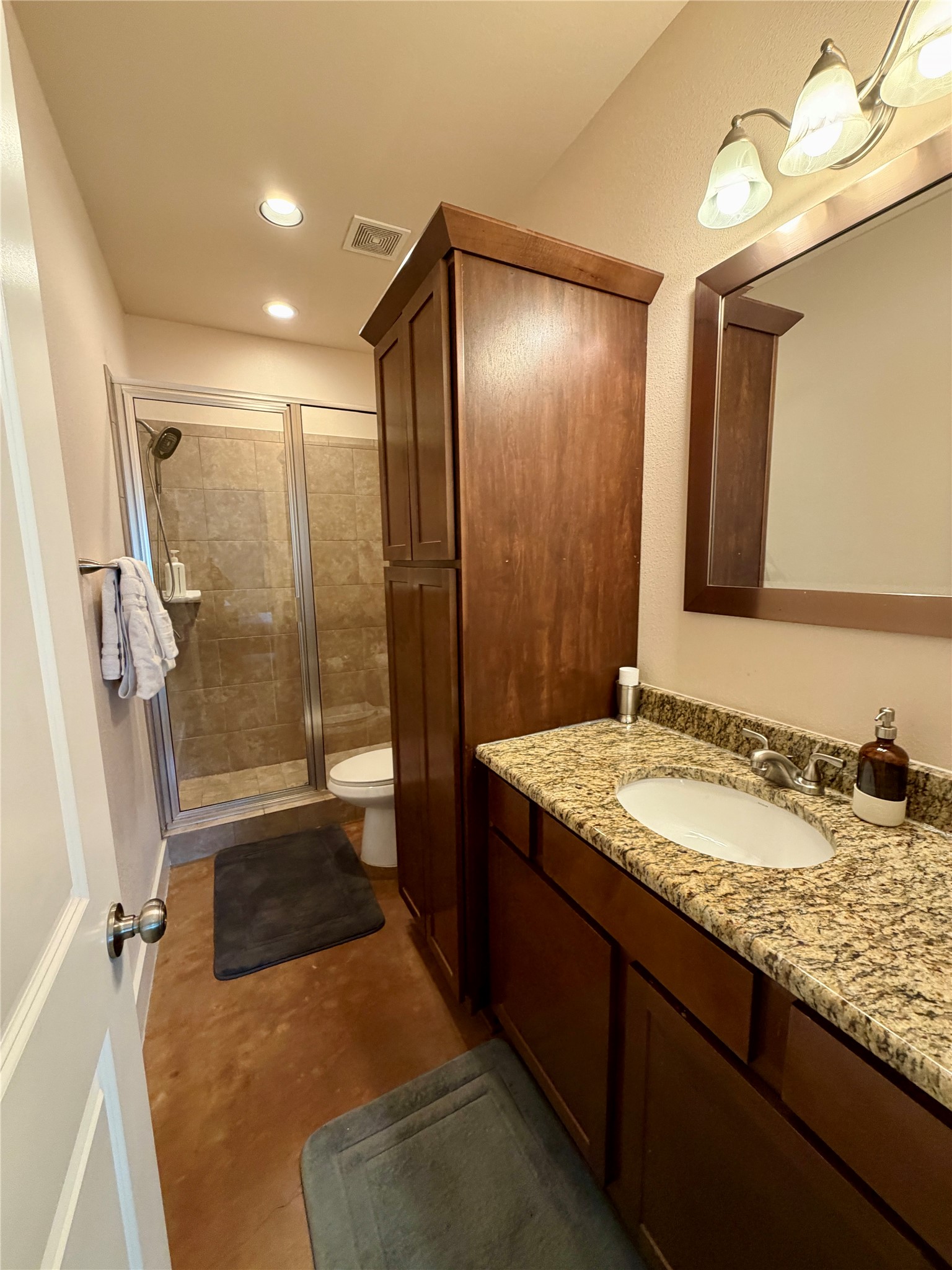 5503 Hiline Road Austin, TX 78734 - Photo 11 of 20 Bathroom with vanity, a walk in shower, recessed lighting, and finished concrete floors