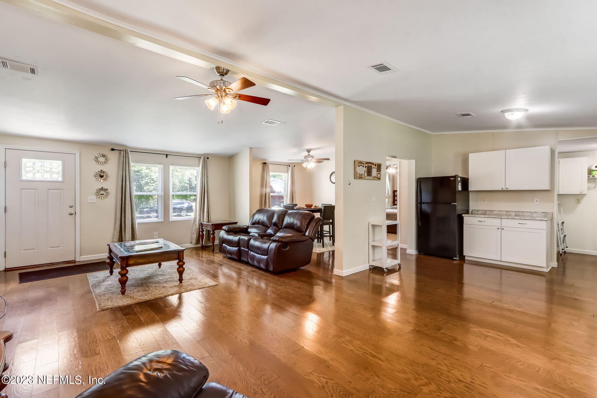 11480 Kaleel Road Jacksonville, FL 32218 - Photo 11 of 31 a living room with furniture dining table and wooden floors