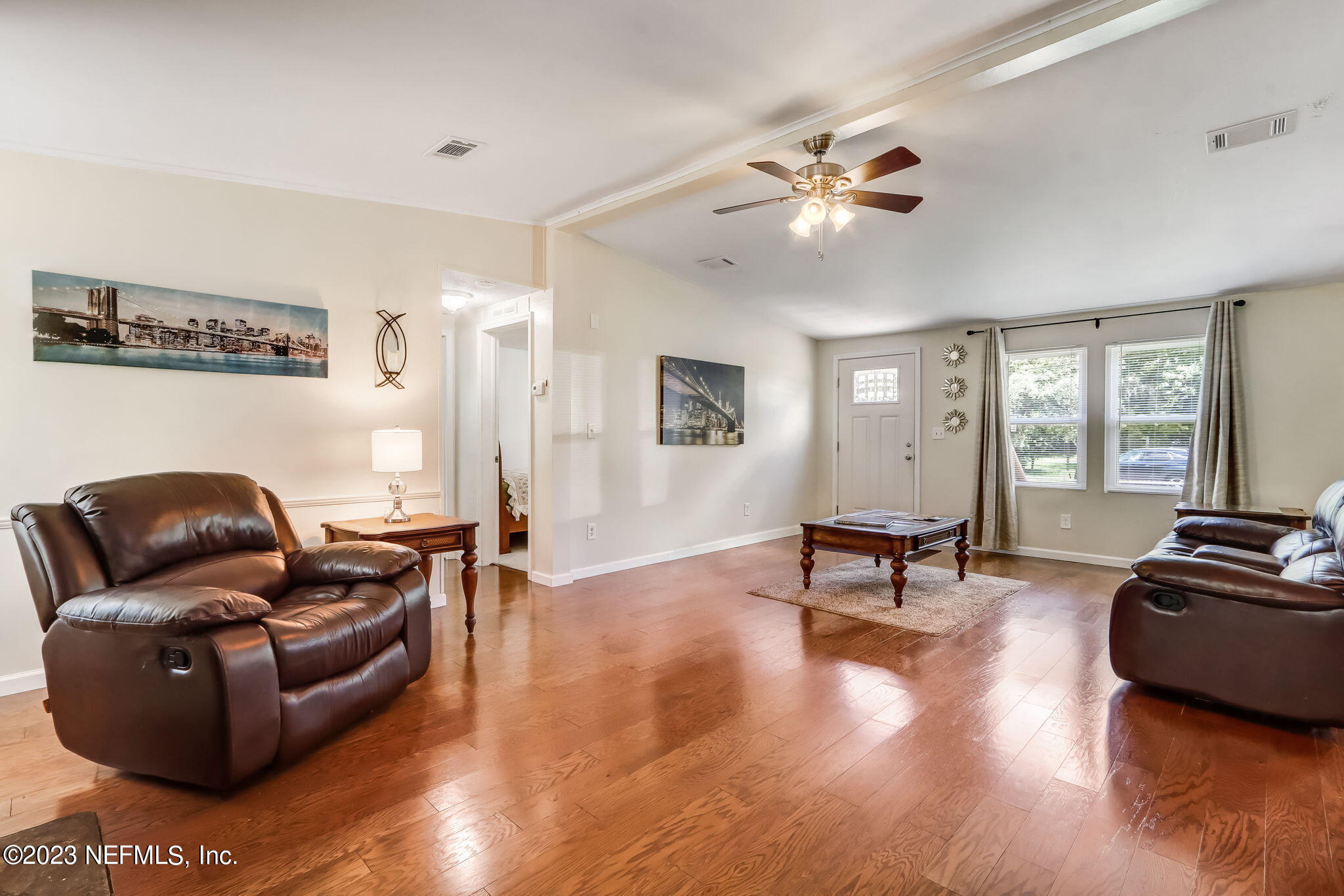 11480 Kaleel Road Jacksonville, FL 32218 - Photo 12 of 31 a living room with furniture and a flat screen tv with wooden floor