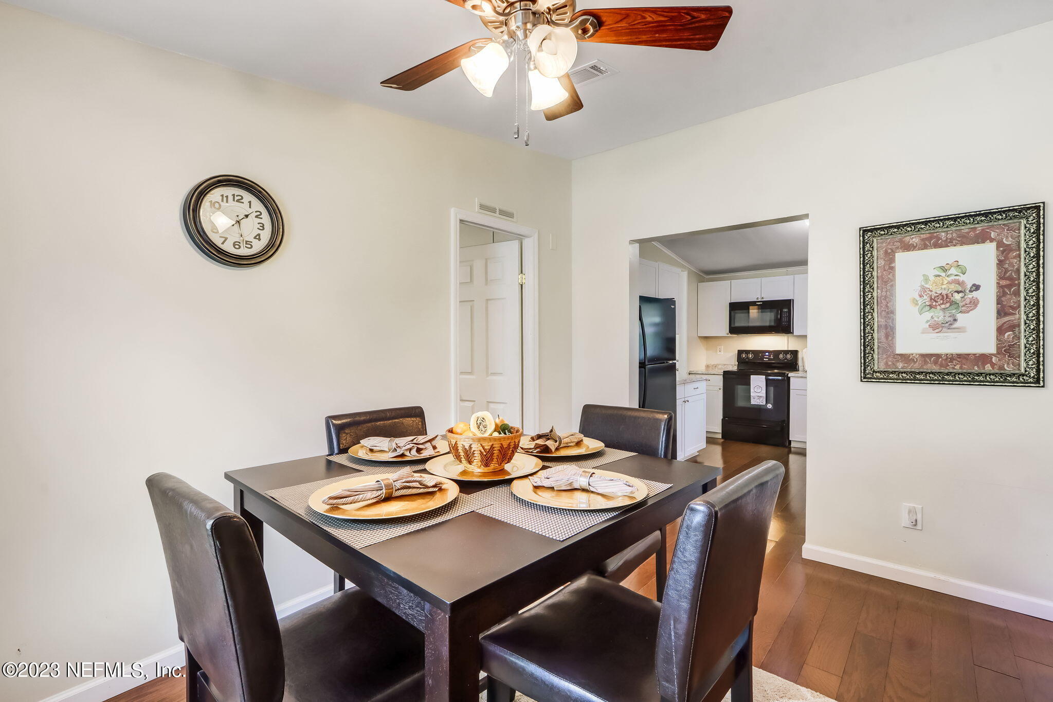 11480 Kaleel Road Jacksonville, FL 32218 - Photo 19 of 31 a view of a dining room with furniture and wooden floor