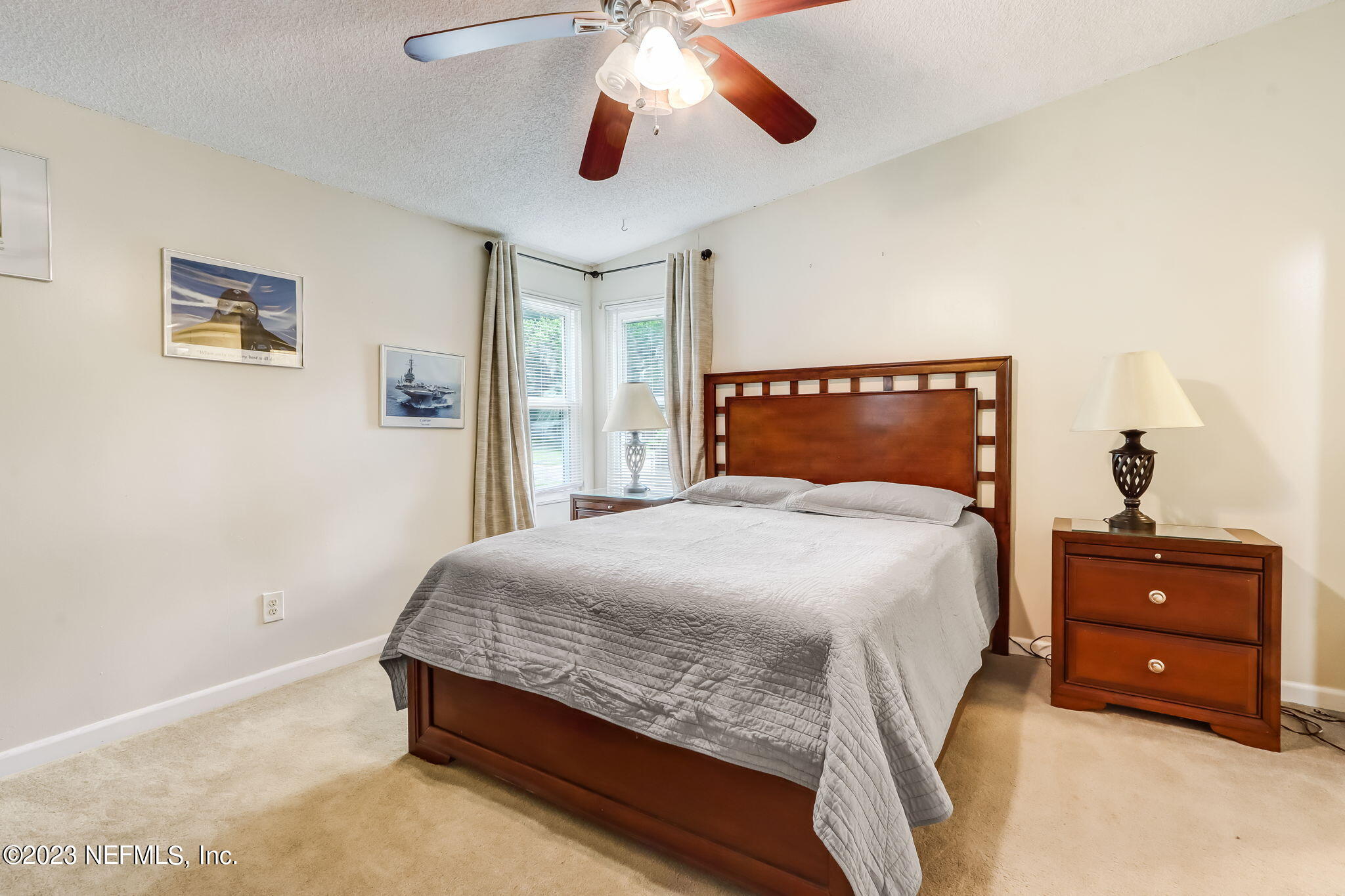 11480 Kaleel Road Jacksonville, FL 32218 - Photo 20 of 31 a bedroom with a bed and a chandelier