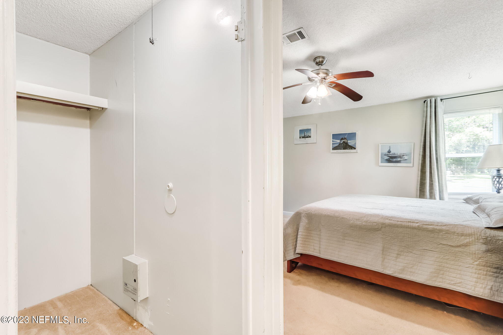 11480 Kaleel Road Jacksonville, FL 32218 - Photo 23 of 31 a bedroom with a bed and a chandelier