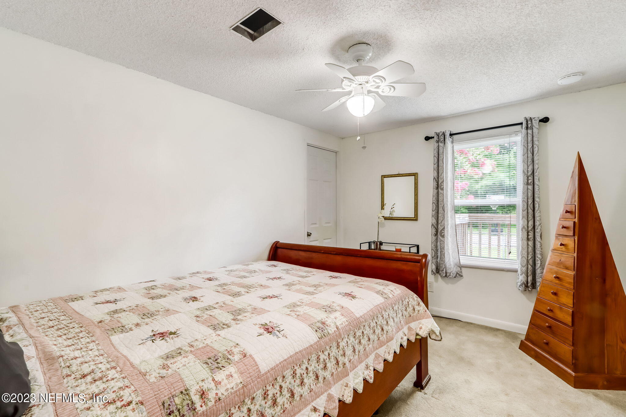 11480 Kaleel Road Jacksonville, FL 32218 - Photo 24 of 31 a bedroom with a large bed and a chandelier