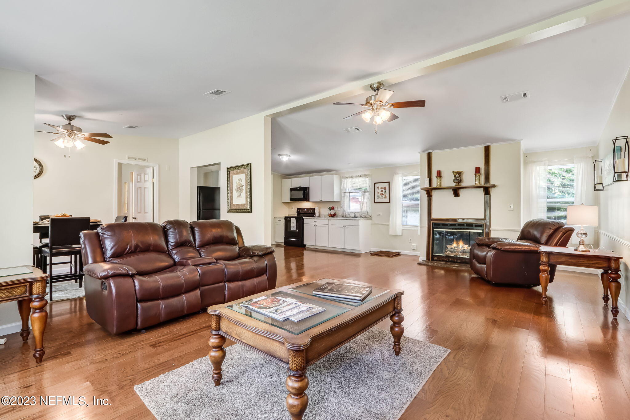 11480 Kaleel Road Jacksonville, FL 32218 - Photo 6 of 31 a living room with furniture a rug and a chandelier