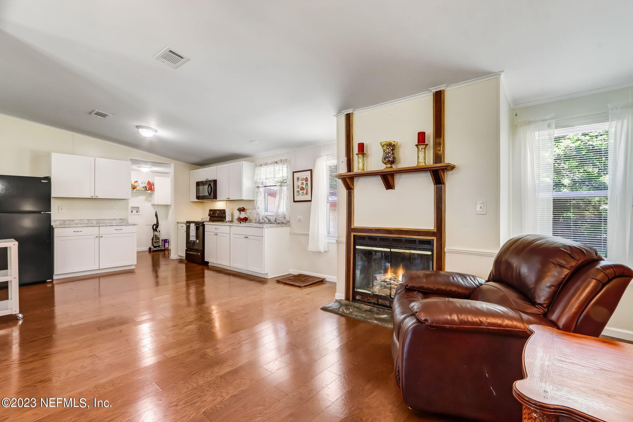 11480 Kaleel Road Jacksonville, FL 32218 - Photo 10 of 31 a living room with furniture and a fireplace