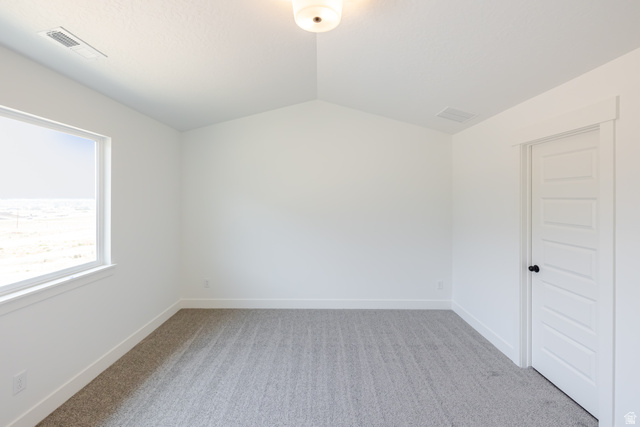 5224 South Acacia Drive, Unit 809 Mapleton, UT 84664 - Photo 16 of 23 Bright room featuring a vaulted ceiling and light gray carpet