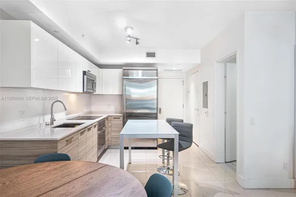 a kitchen with a sink cabinets and window