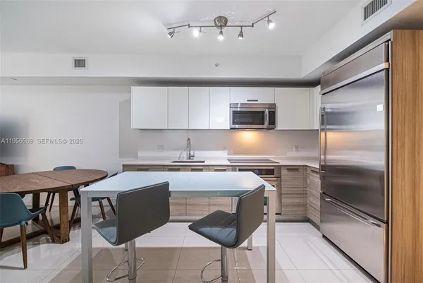 a kitchen with a stove a sink and a refrigerator