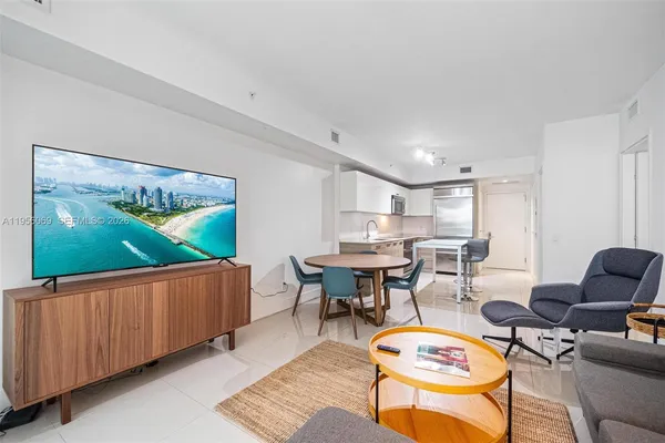 a living room with furniture a rug and a flat screen tv