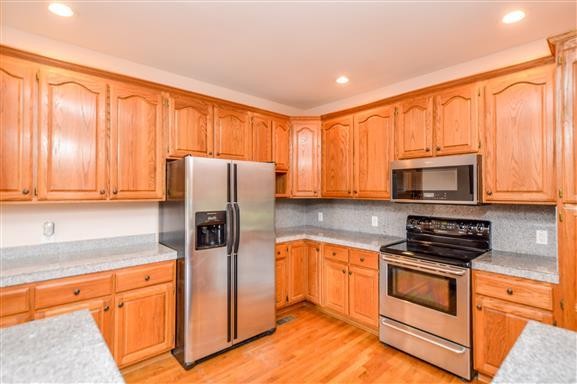 284 Northup Road Portland, TN 37148 - Photo 9 of 30 a kitchen with stainless steel appliances granite countertop a refrigerator stove microwave and sink