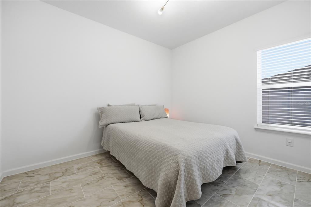 511 Northwest 4th Street Williston, FL 32696 - Photo 23 of 33 a large bed sitting in a bedroom next to a window