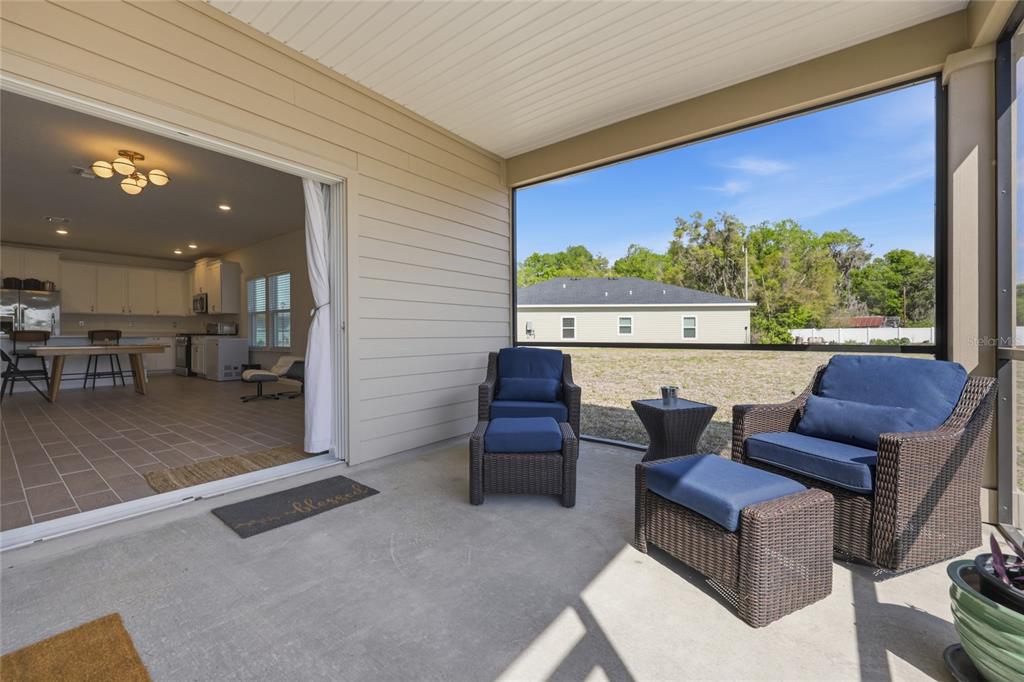 511 Northwest 4th Street Williston, FL 32696 - Photo 30 of 33 a living room with furniture a floor to ceiling window and an outdoor view
