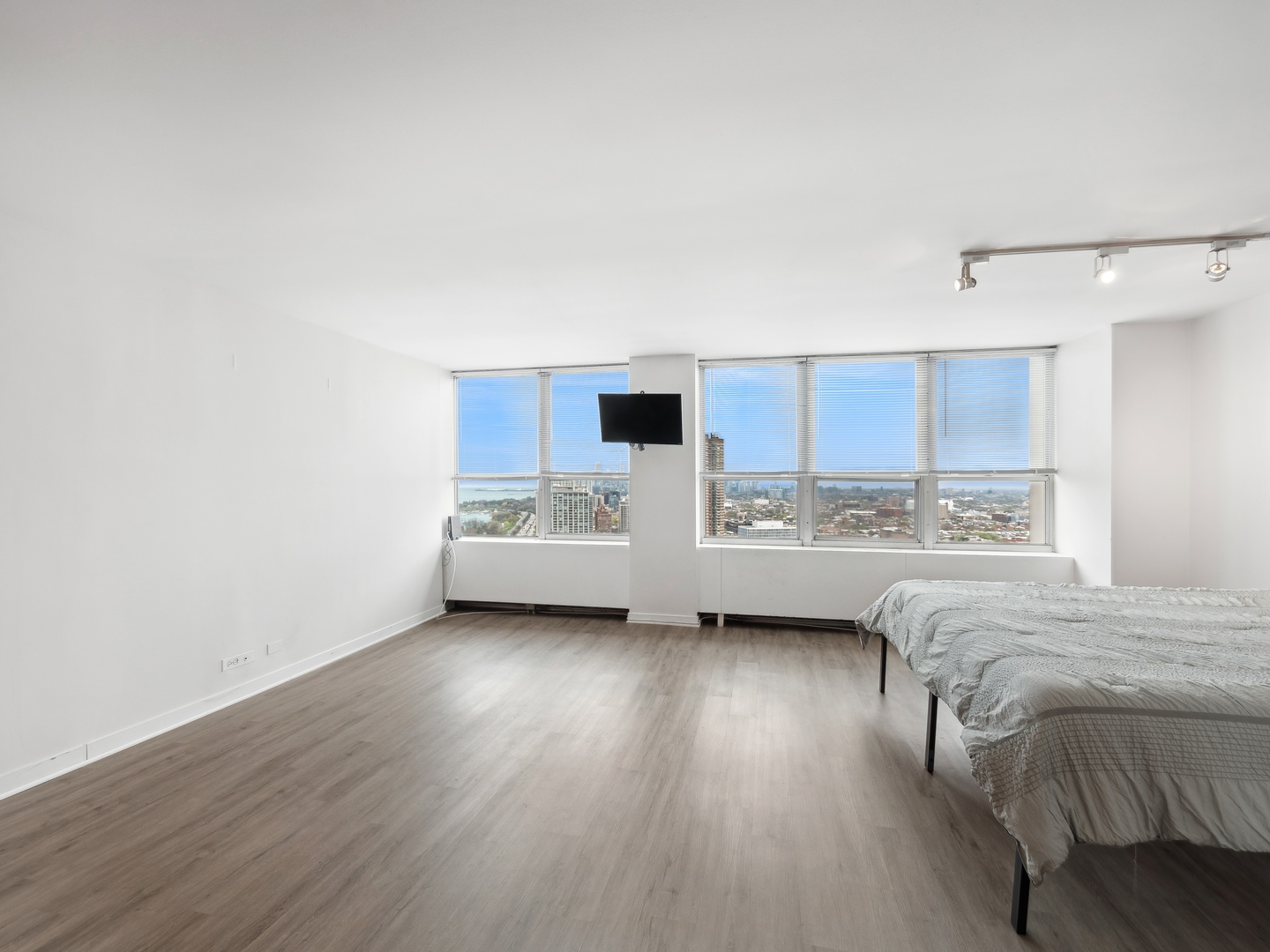 655 West Irving Park Road, Unit 3305 Chicago, IL 60613 - Photo 3 of 14 a view of a bedroom with furniture and wooden floor