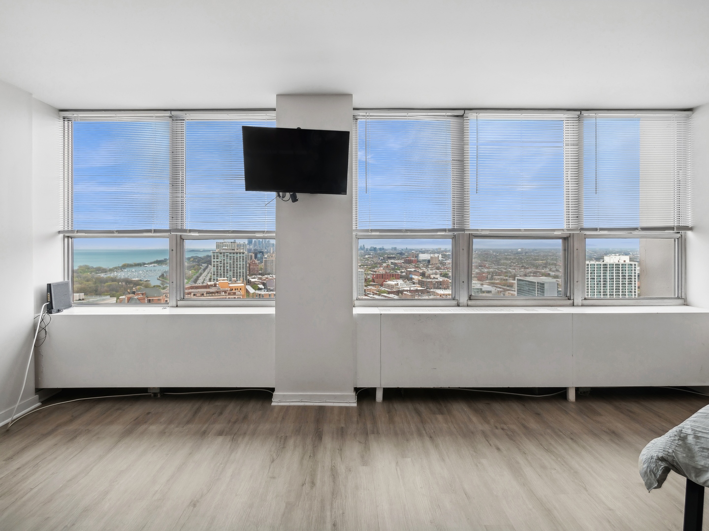 655 West Irving Park Road, Unit 3305 Chicago, IL 60613 - Photo 6 of 14 a view of an empty room with wooden floor and a window
