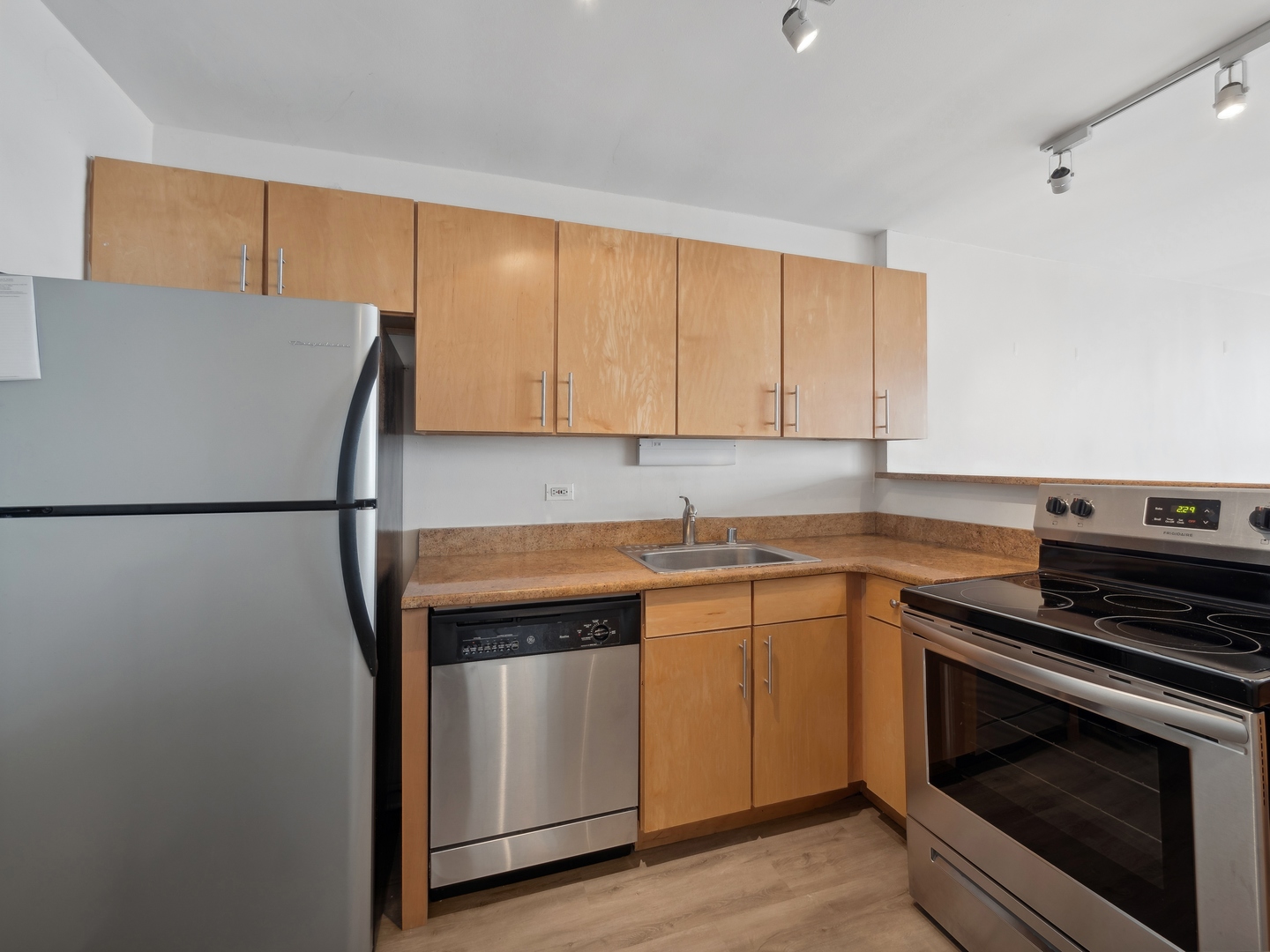 655 West Irving Park Road, Unit 3305 Chicago, IL 60613 - Photo 9 of 14 a kitchen with stainless steel appliances granite countertop a stove a sink and a refrigerator