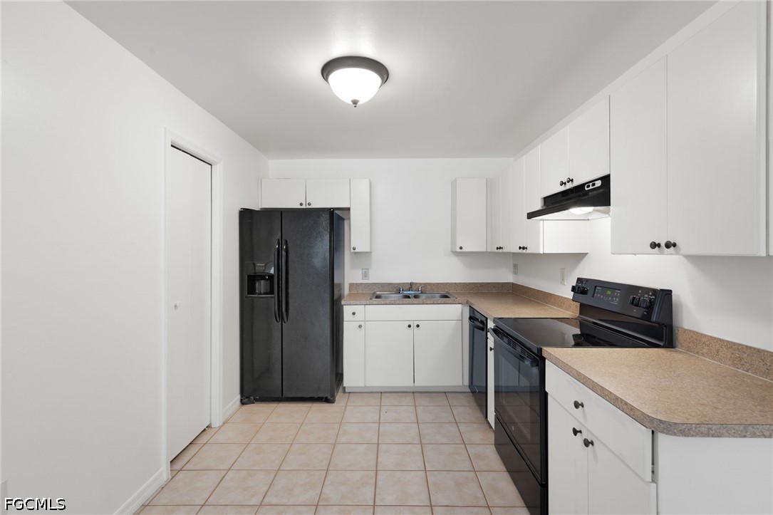 221 Meadow Road Lehigh Acres, FL 33973 - Photo 2 of 13 a kitchen with a sink cabinets and stainless steel appliances