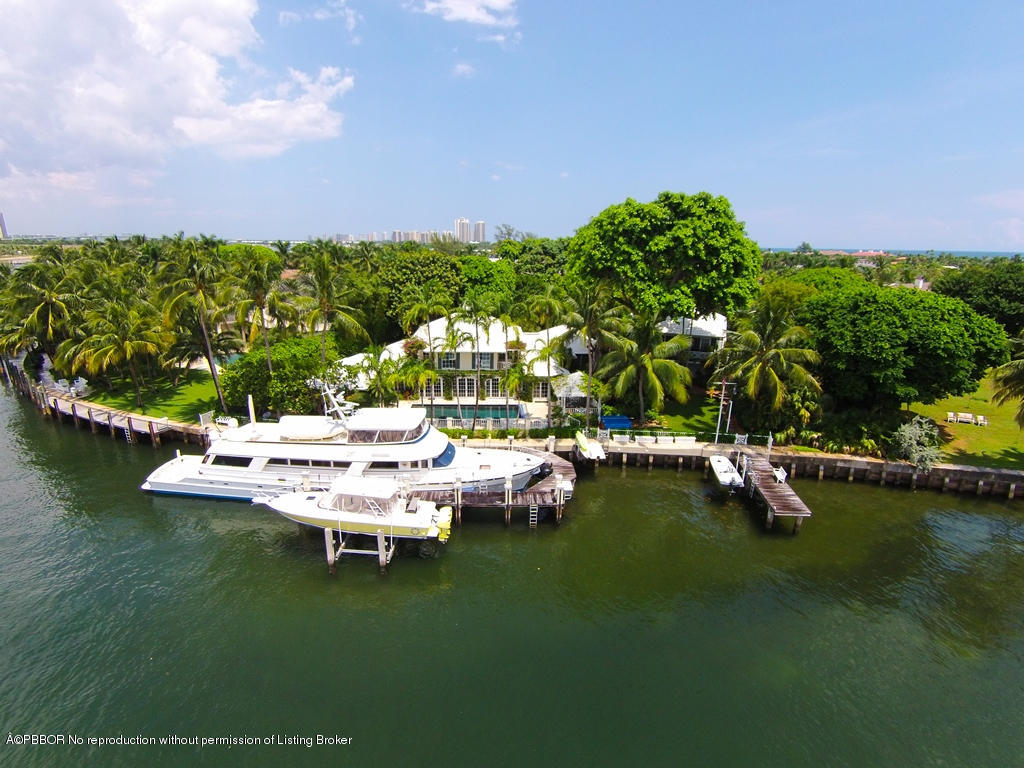 400 Caribbean Road Palm Beach, FL 33480 - Photo 1 of 45 a view of a lake with lawn chairs and large trees