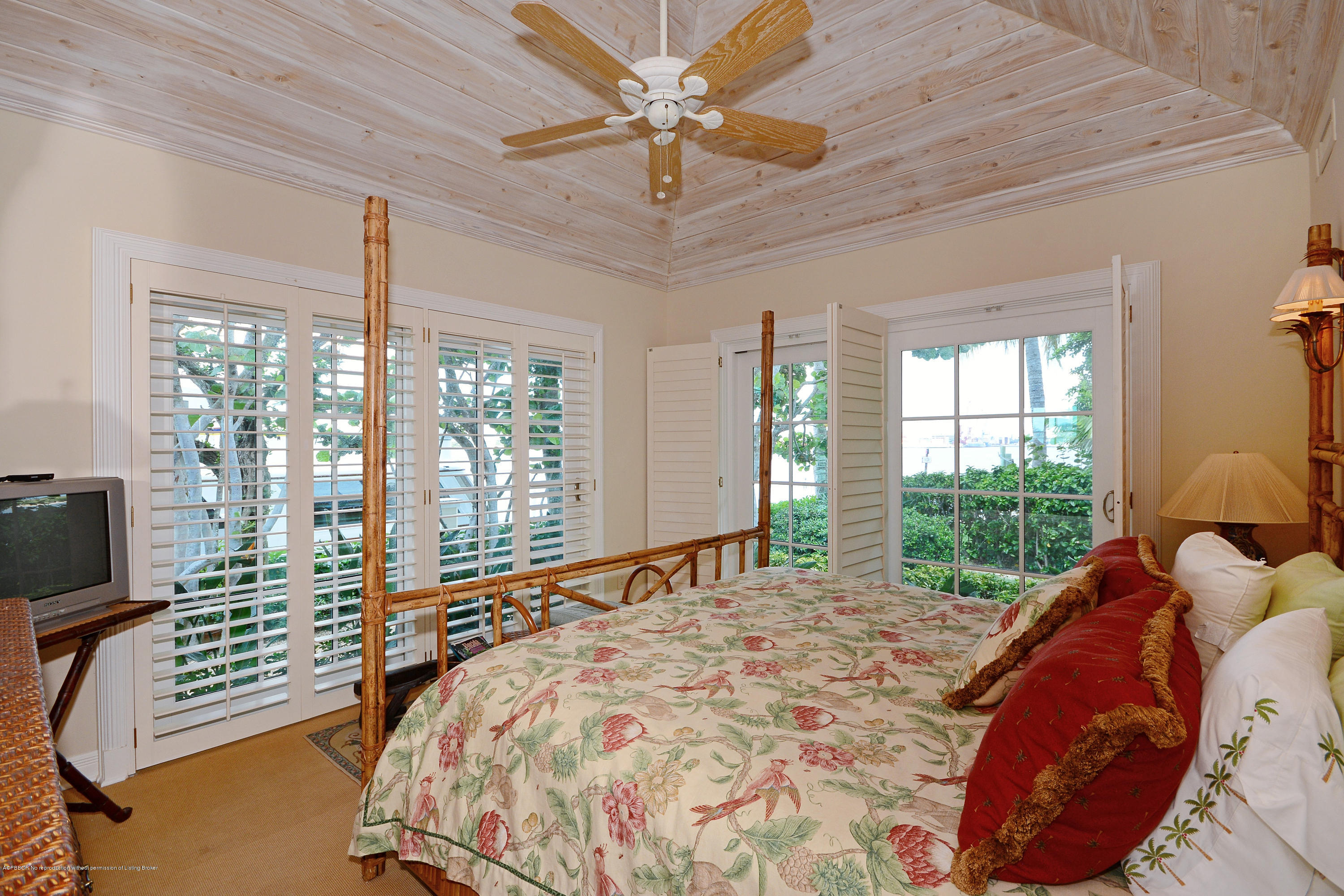 400 Caribbean Road Palm Beach, FL 33480 - Photo 16 of 45 a bed sitting in a bedroom next to a window
