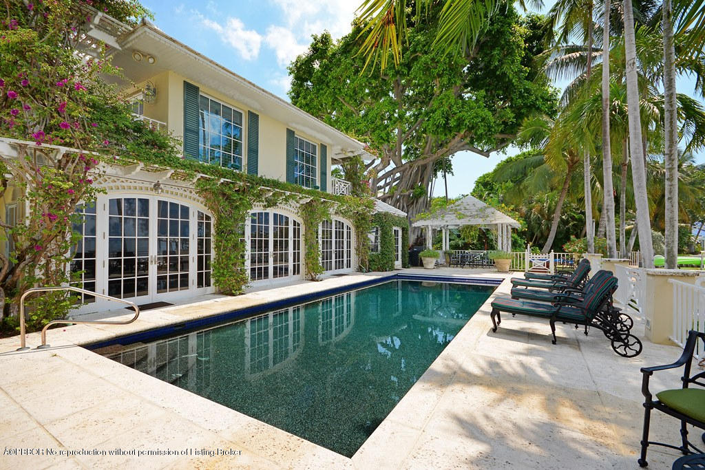 400 Caribbean Road Palm Beach, FL 33480 - Photo 18 of 45 a view of a house with swimming pool and sitting area