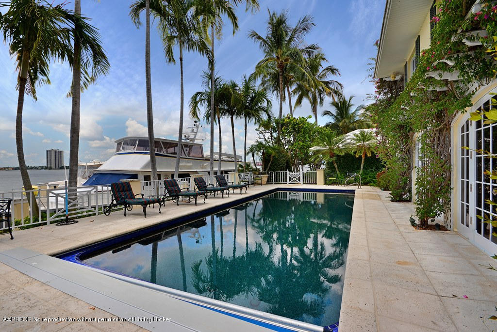 400 Caribbean Road Palm Beach, FL 33480 - Photo 19 of 45 a view of swimming pool with outdoor seating and plants