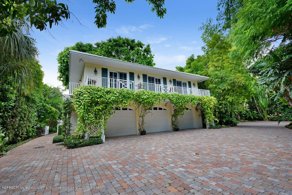 400 Caribbean Road Palm Beach, FL 33480 - Photo 22 of 45 a view of a house with potted plants and large trees