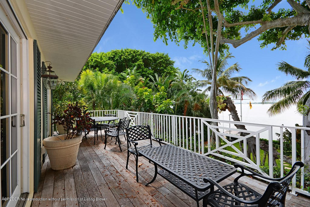 400 Caribbean Road Palm Beach, FL 33480 - Photo 25 of 45 a view of balcony with wooden floor outdoor seating and plants