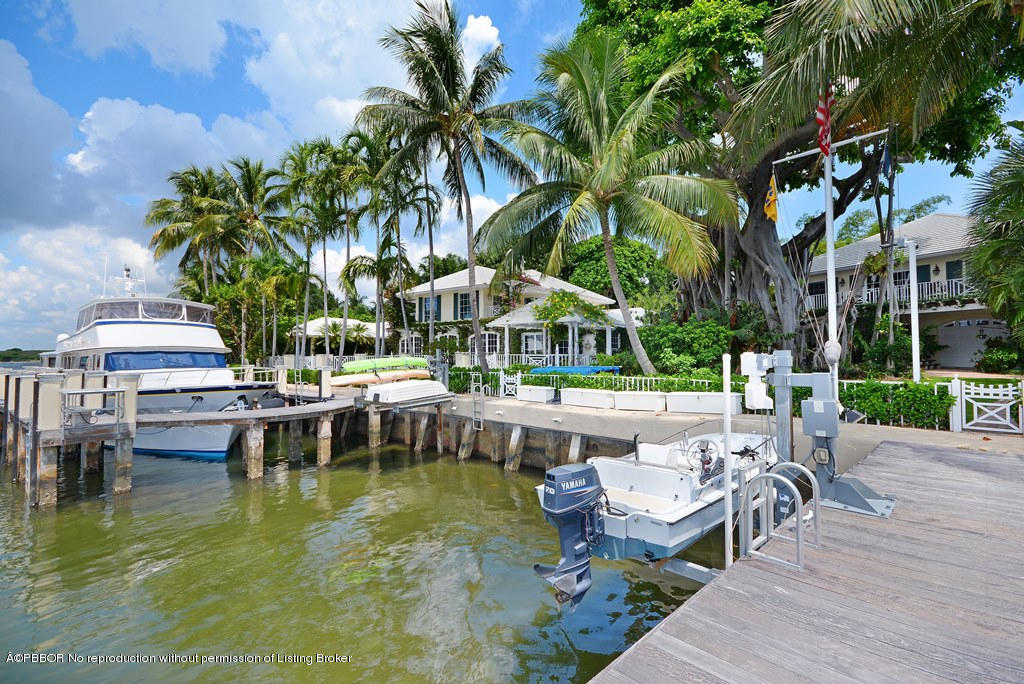 400 Caribbean Road Palm Beach, FL 33480 - Photo 33 of 45 a view of a swimming pool with chairs