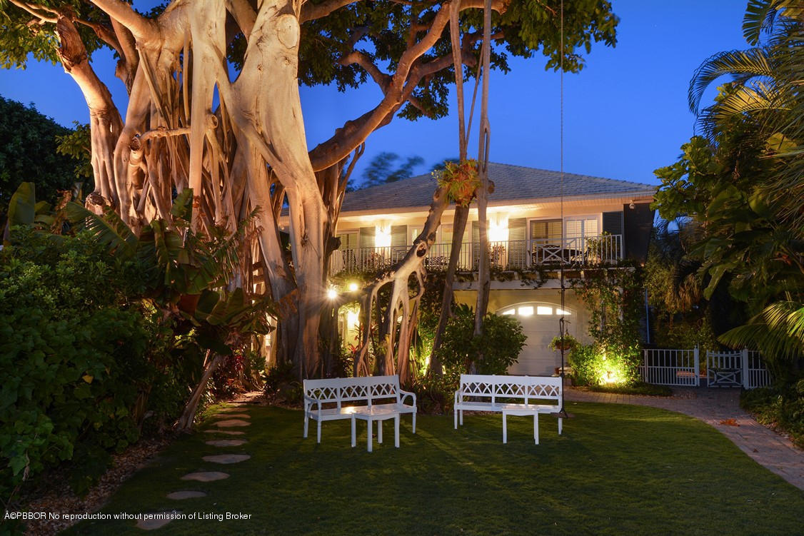 400 Caribbean Road Palm Beach, FL 33480 - Photo 45 of 45 a view of a patio with table and chairs and potted plants and large trees