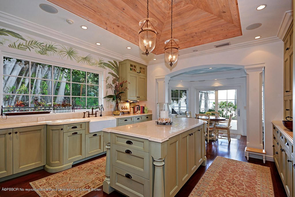 400 Caribbean Road Palm Beach, FL 33480 - Photo 8 of 45 a kitchen with a sink stove and wooden cabinets