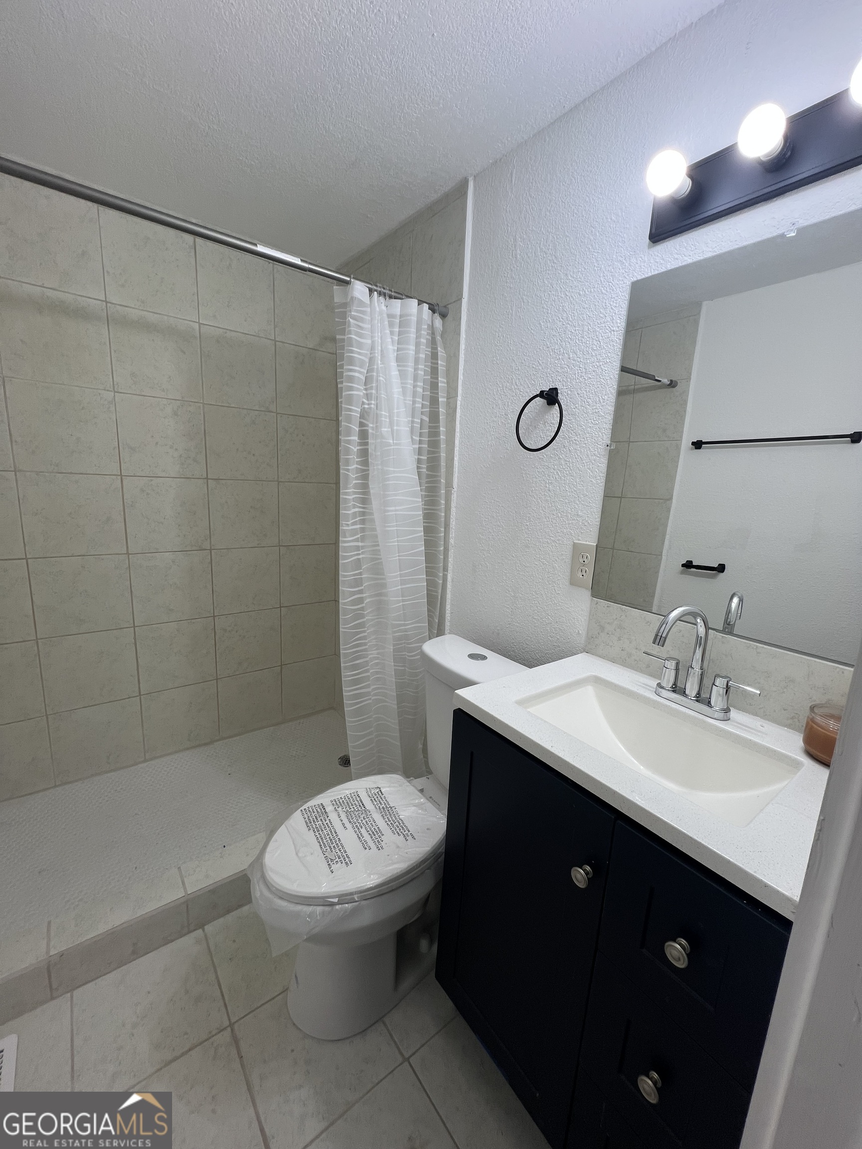 101 McGee Street LaGrange, GA 30241 - Photo 11 of 15 a bathroom with a sink a toilet and shower