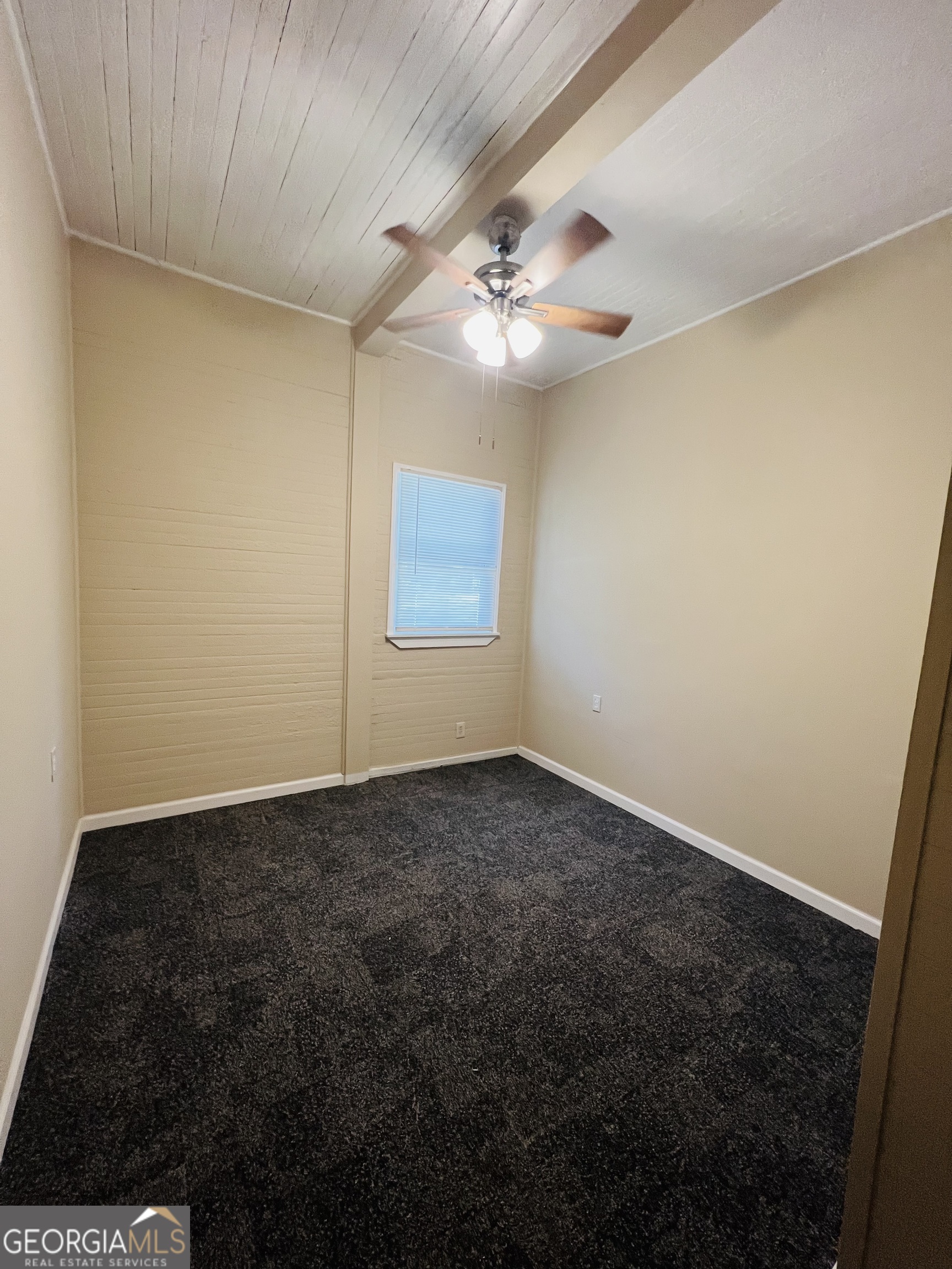 101 McGee Street LaGrange, GA 30241 - Photo 12 of 15 an empty room with a ceiling fan and a window