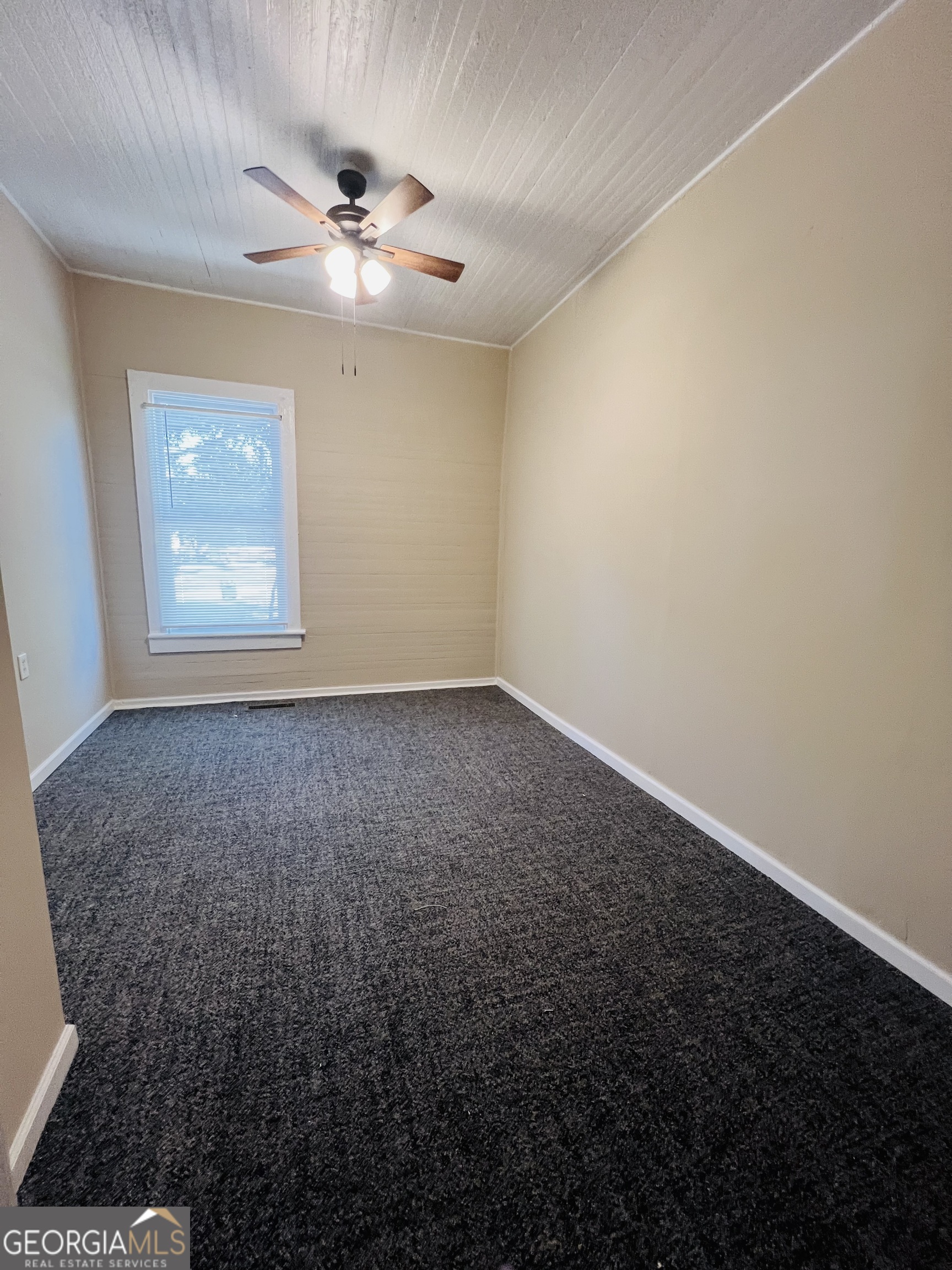 101 McGee Street LaGrange, GA 30241 - Photo 13 of 15 an empty room with a ceiling fan and window