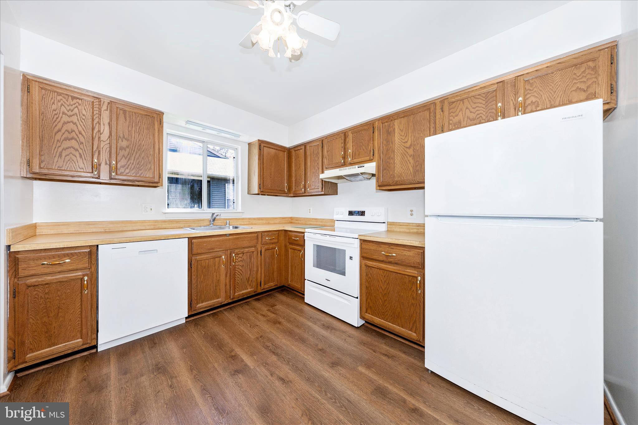 5738 Box Elder Court Frederick, MD 21703 - Photo 12 of 50 a kitchen with white cabinets and white appliances