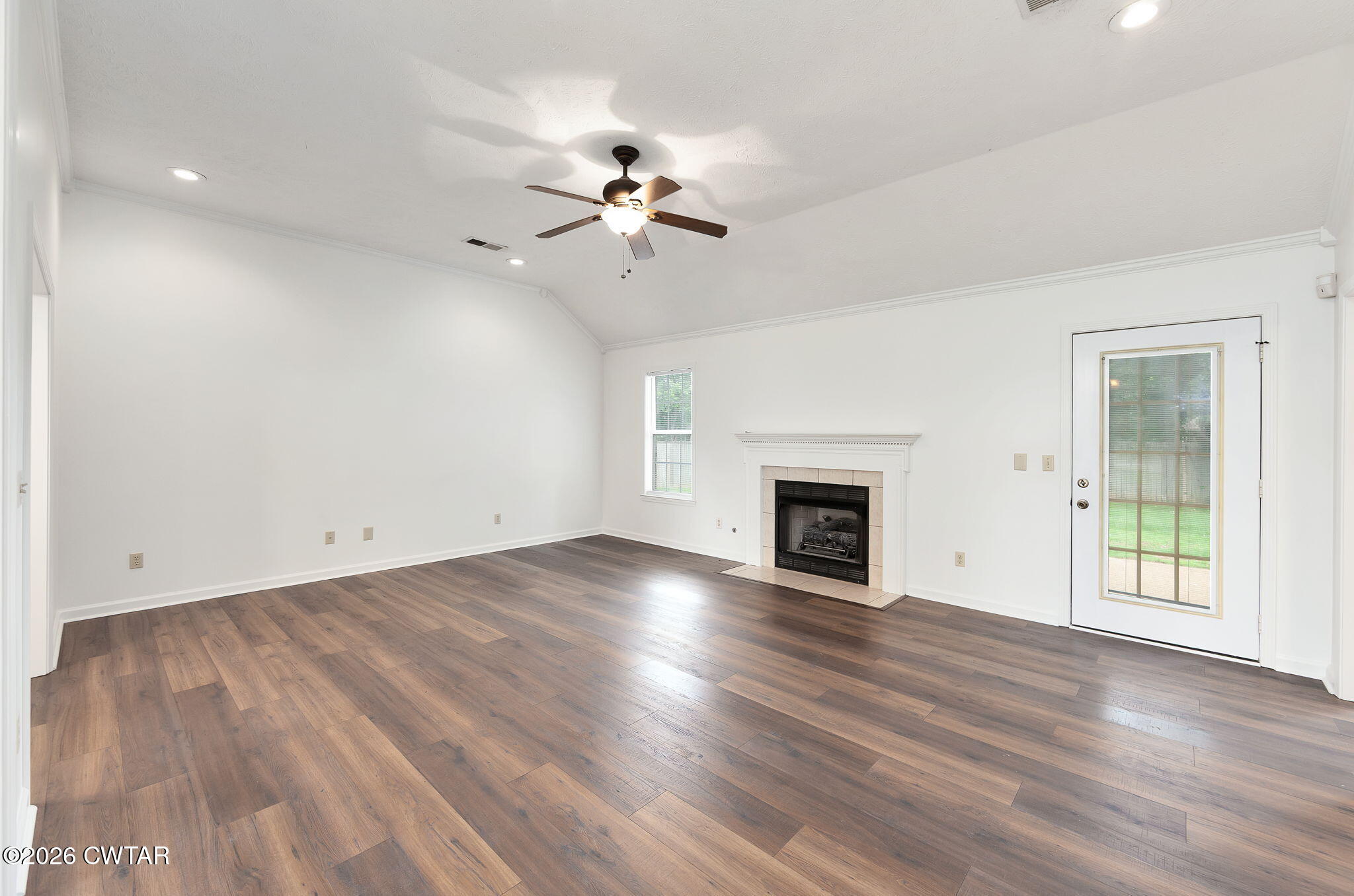 96 Sundown Drive Jackson, TN 38305 - Photo 4 of 28 a view of empty room with wooden floor and fireplace