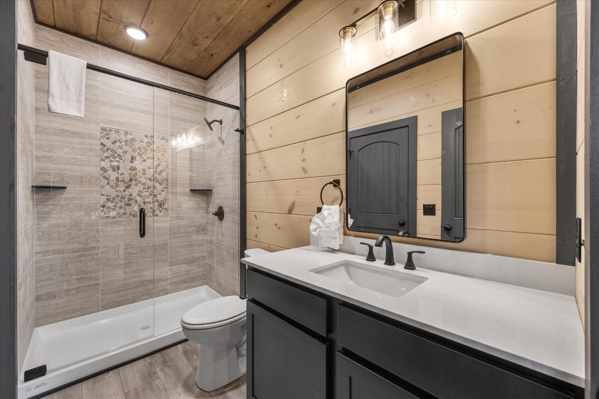 297 Rambling Crk Way Sevierville, TN 37862 - Photo 32 of 84 a bathroom with a sink a toilet a mirror and shower