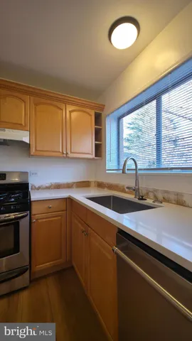 a kitchen with stainless steel appliances granite countertop a stove and a sink