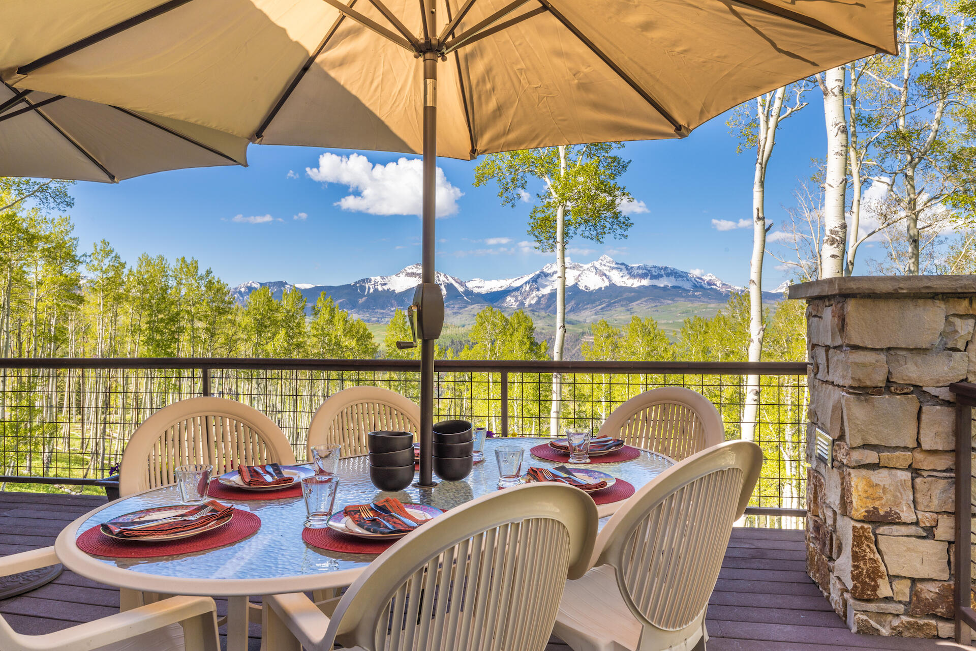 107 Joaquin Road Telluride, CO 81435 - Photo 5 of 7 a view of a patio with couches chairs under an umbrella