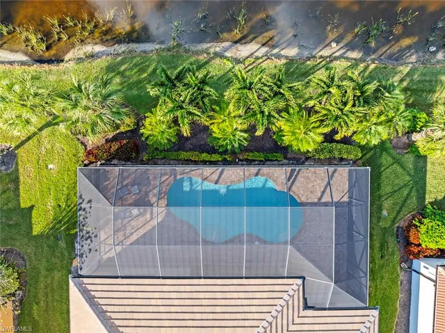 an aerial view of residential houses with outdoor space and swimming pool